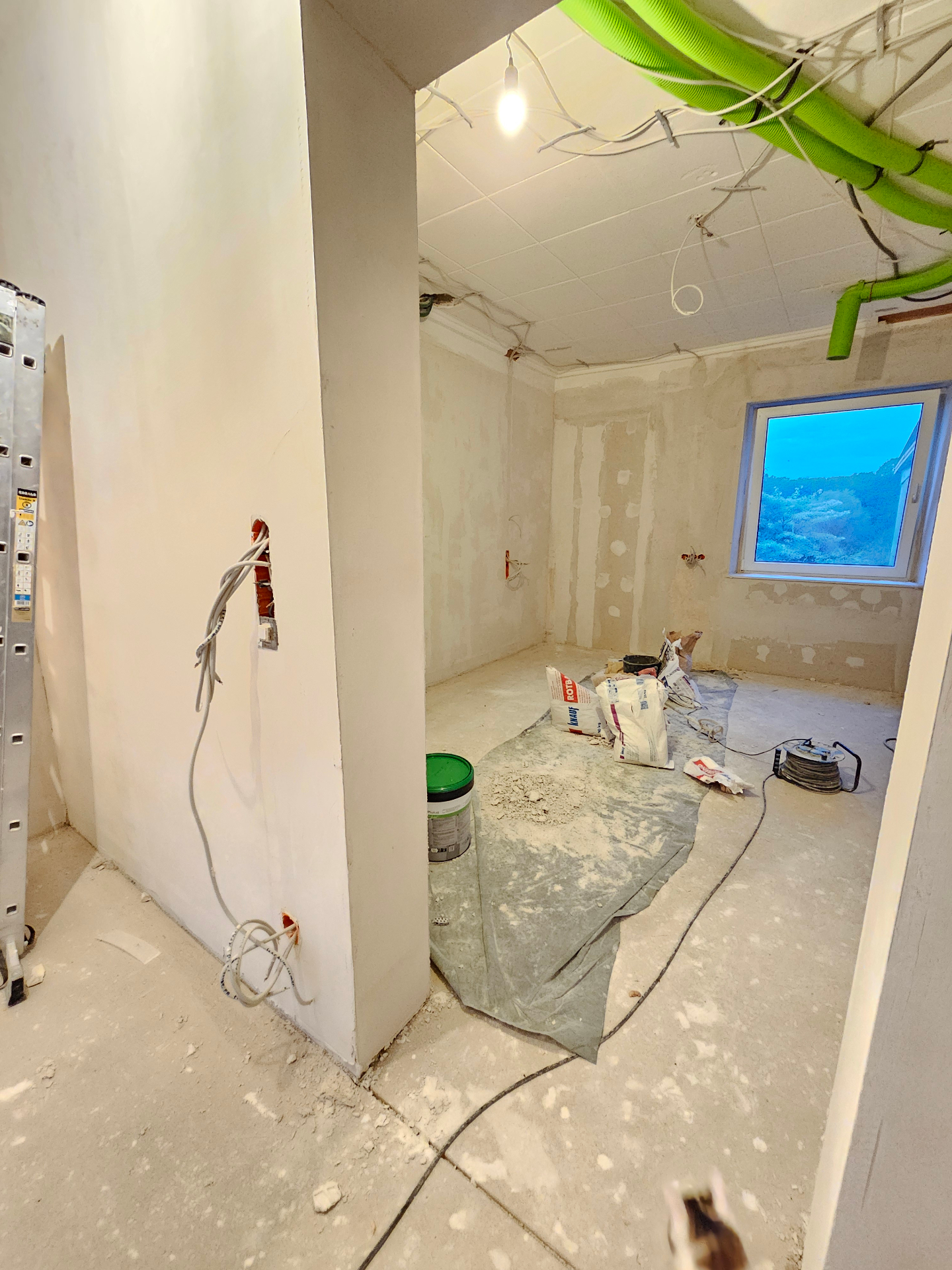 Plastered room with new partitions, wiring and ventilation in progress