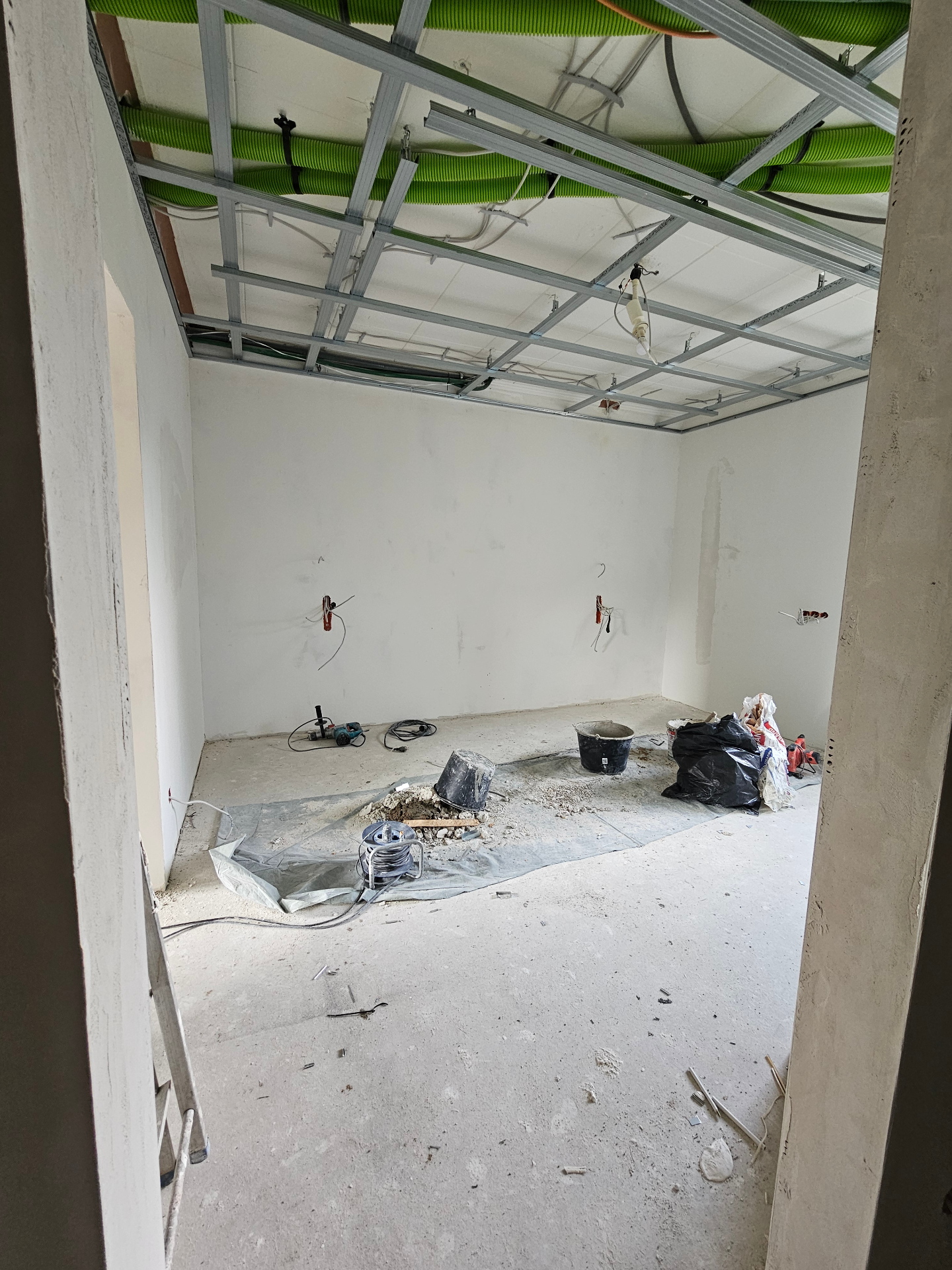 Wide view of a suspended ceiling frame with ventilation ducts