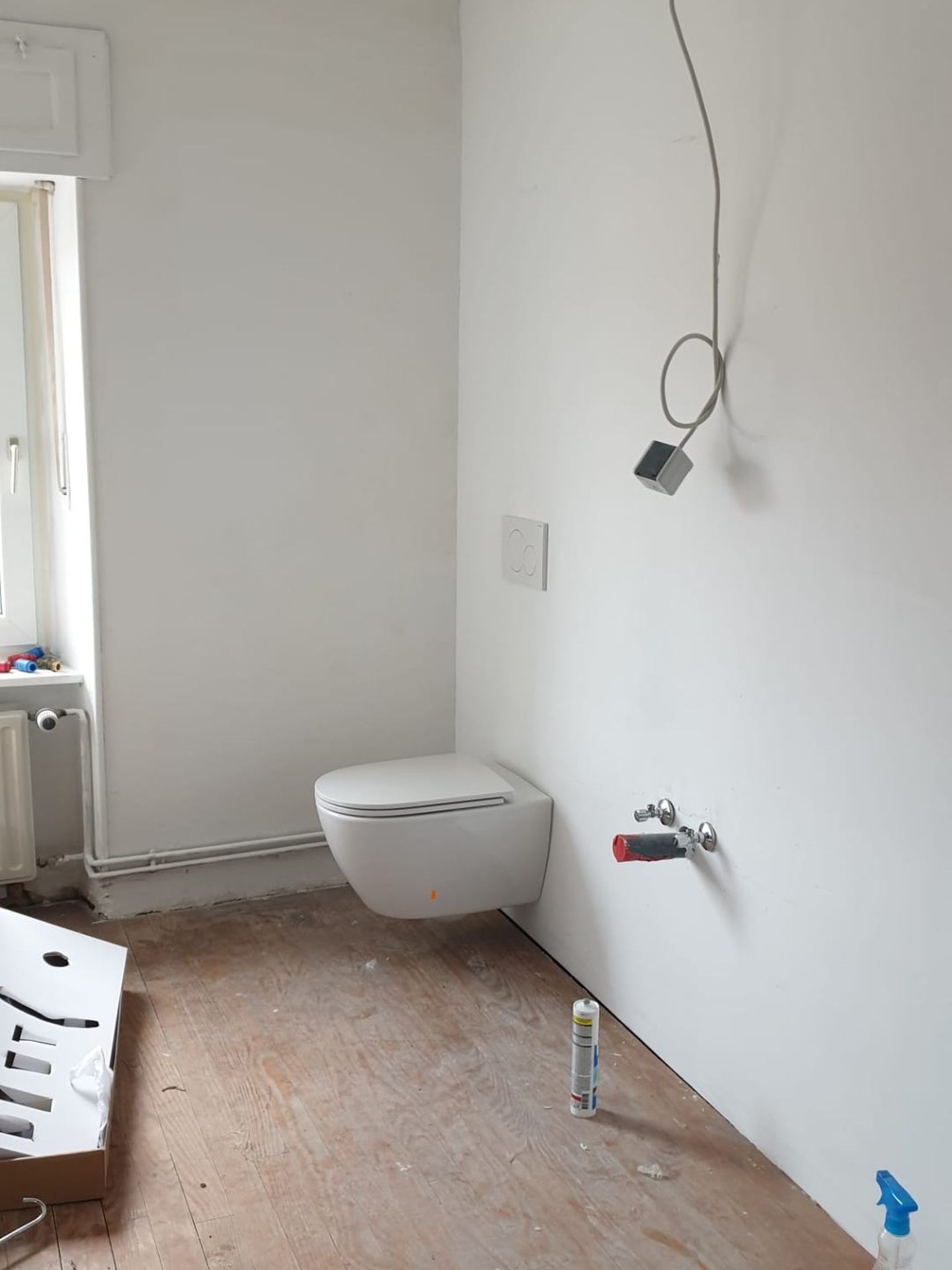 New plumbing, drywall & wall-hung toilet — after