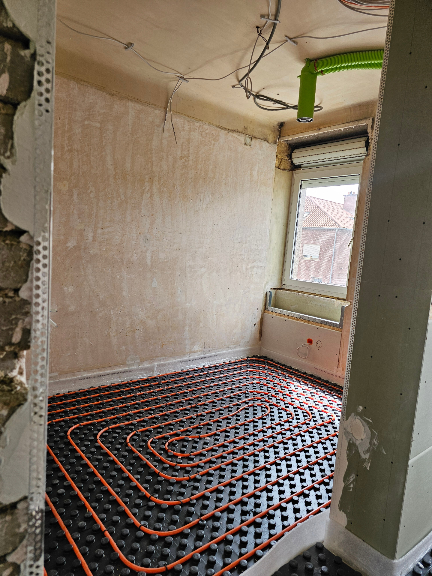 Underfloor heating loops laid on insulation panels