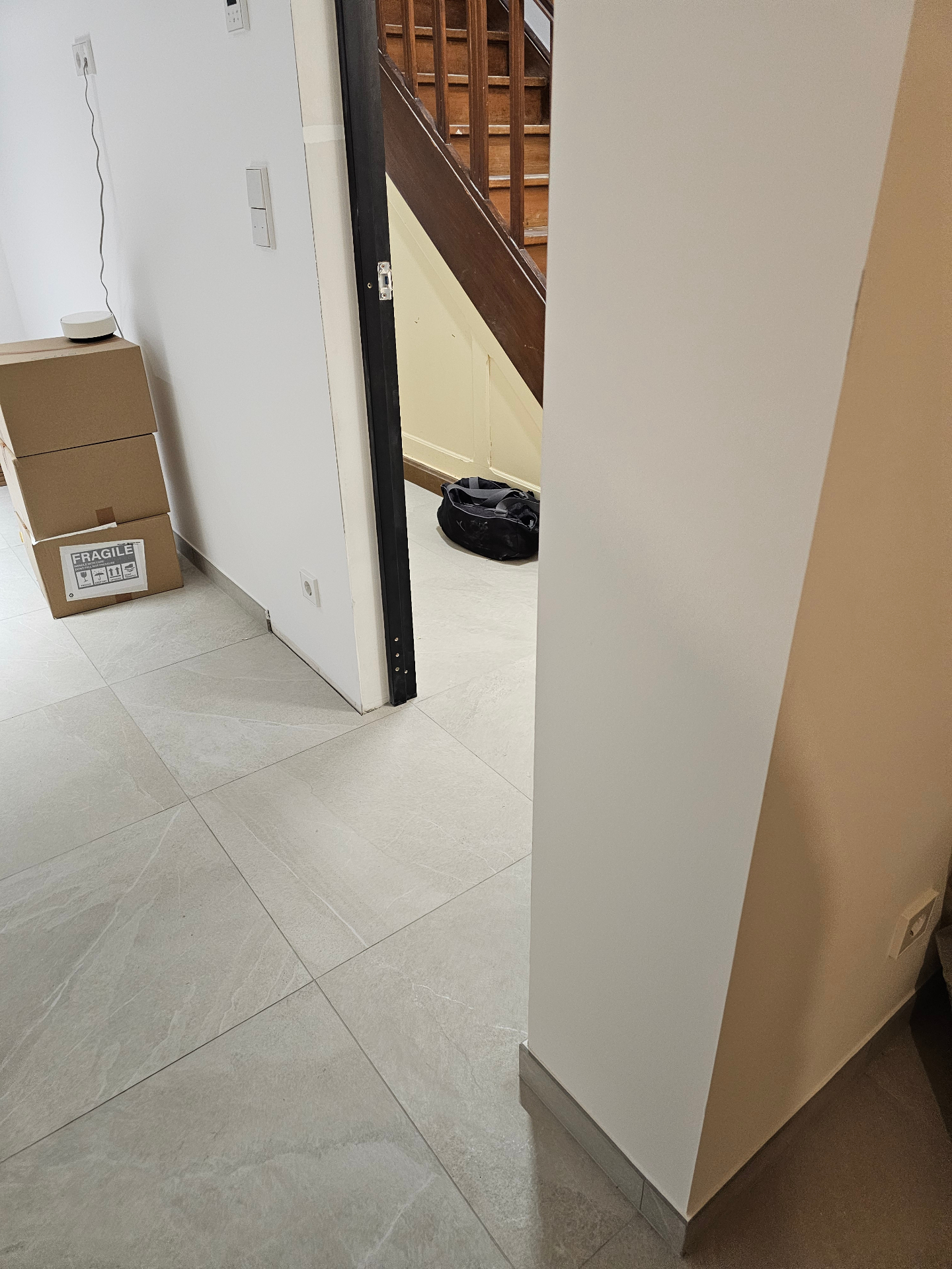Finished tiled hallway and doorway near the staircase